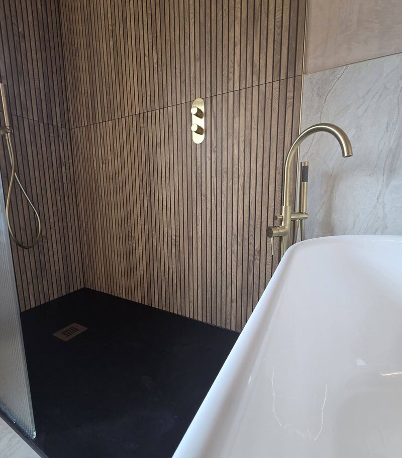 Renovated bathroom with fluted bath, sage tiles and terrazzo floor
